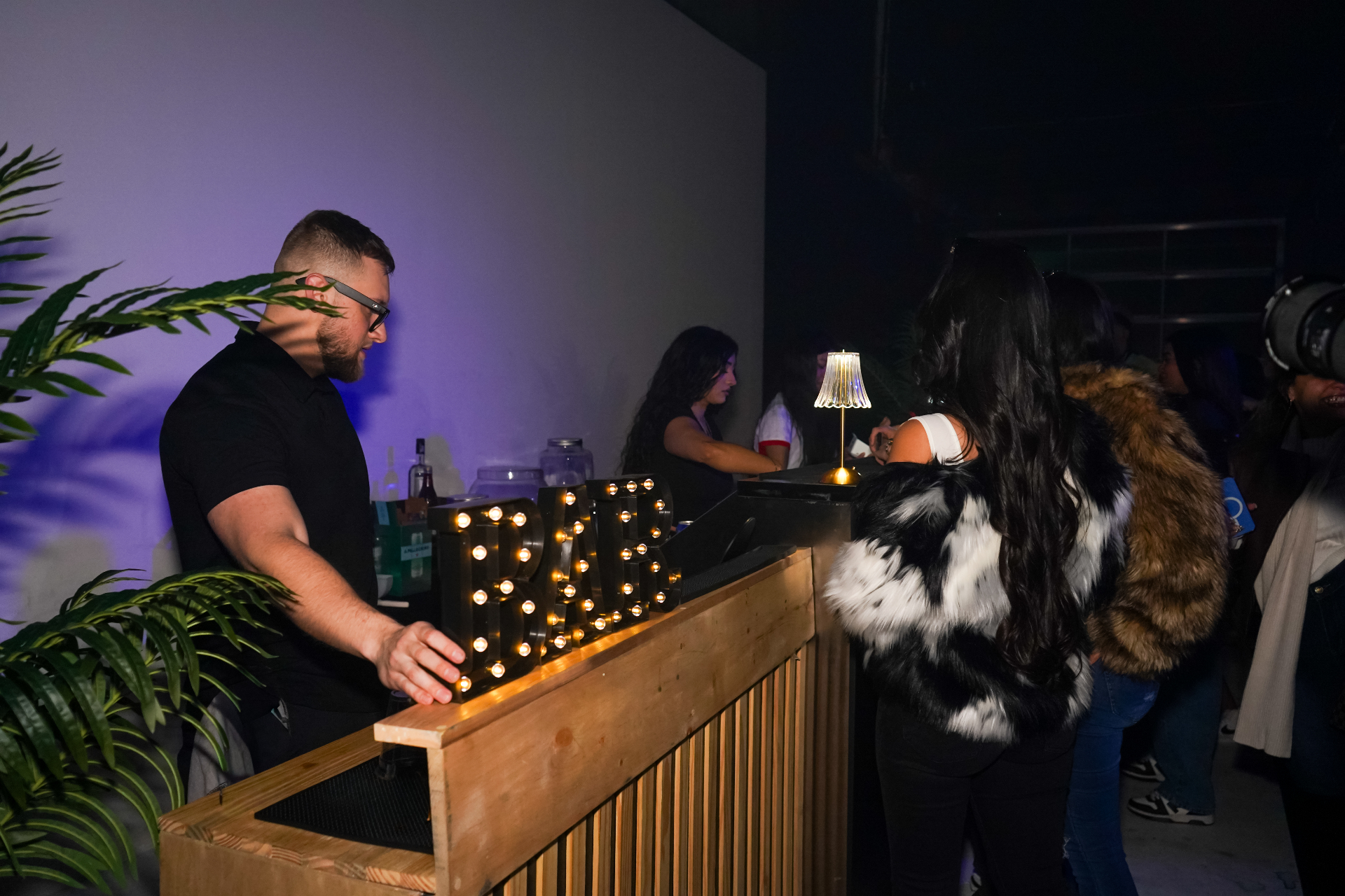 Dos Santos bartender serving guests at a lit mobile bar